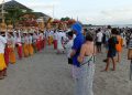 Sejumlah wisatawan antusias menyaksikan proses upacara Melasti di Seminyak, Badung, Minggu (19/3/2023). (Triwidiyanti/detikBali)